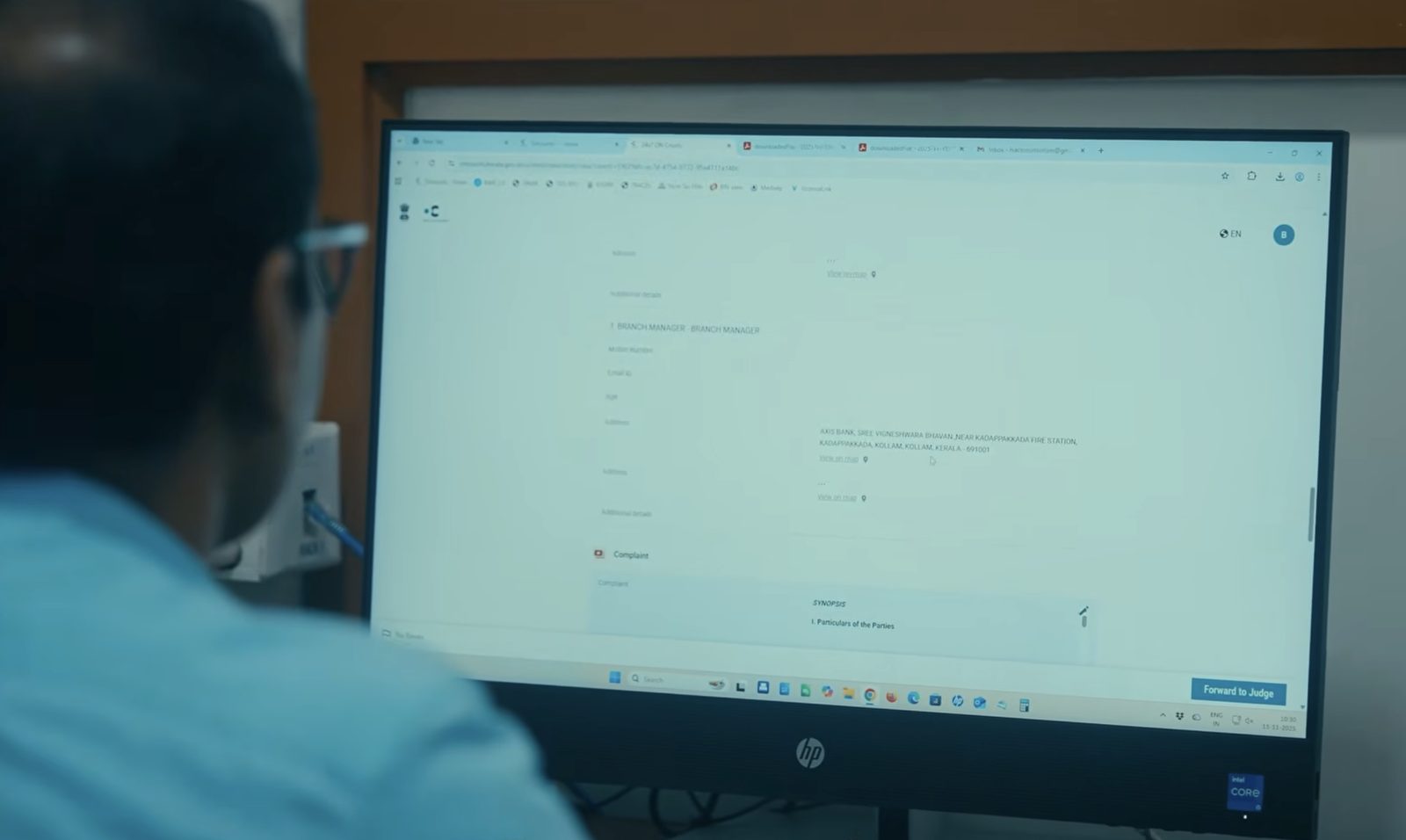 A court officer reviewing a case file in DRISTI